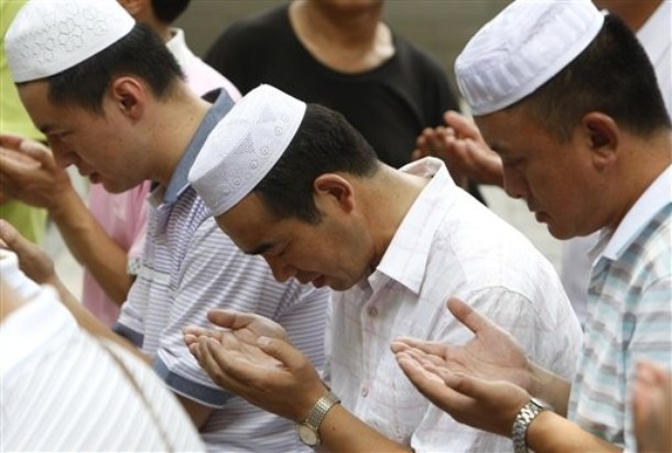 Chinese Muslims attend Friday prayers at the Niu Jie mosque in Beijing, China, Friday, July 10, 2009. Several mosques in riot-hit Urumqi opened for Friday prayers, despite notices posted earlier saying they would be closed in the wake of ethnic violence that left 156 dead. (AP Photo/Greg Baker)